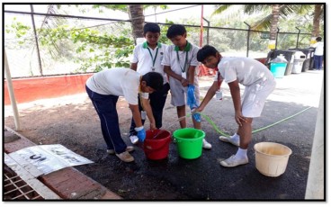 Work Education- Students rendering their services towards wet composting.